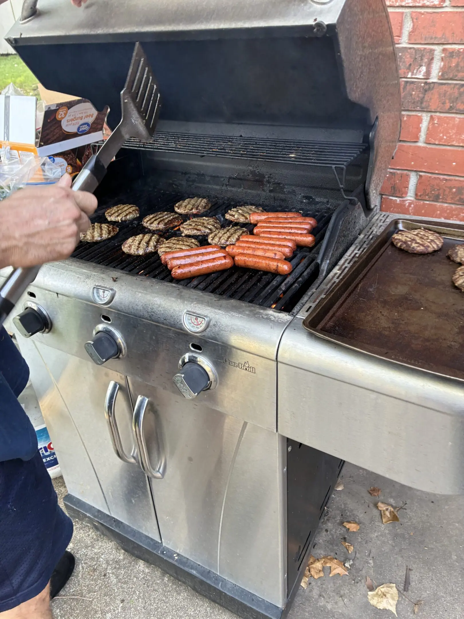 Grilling burgers and hot dogs outside