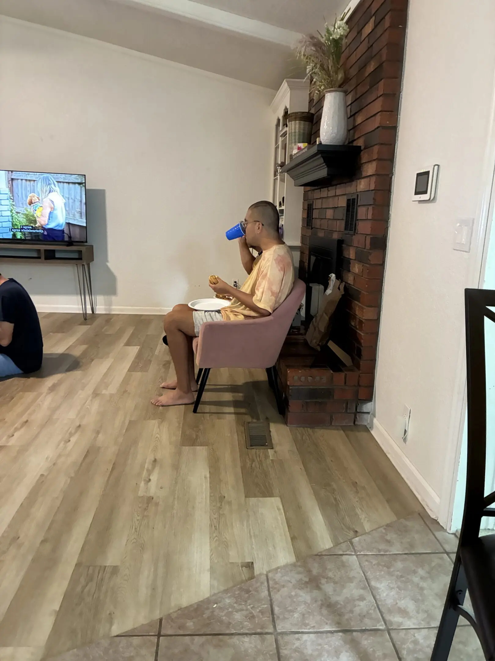 Person watching TV while dining
