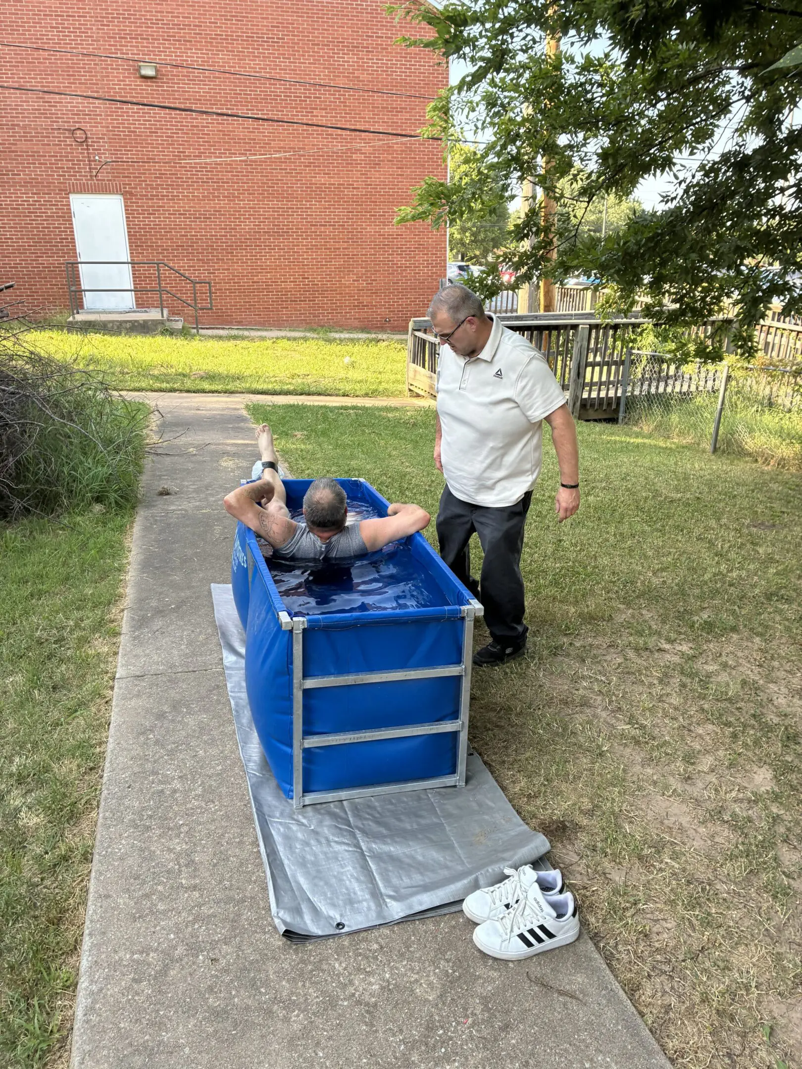 Man in blue tank outside